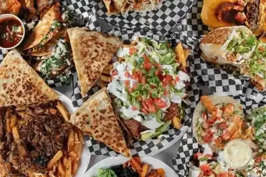 A delicious spread of authentic Mexican tacos and appetizers at Contigo Tacobar in Mississauga.