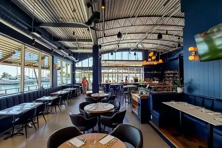 Modern interior of a waterfront restaurant in Pickering with a view of the lake.