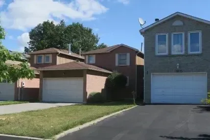 Street view of residential properties with spacious driveways in Village East.