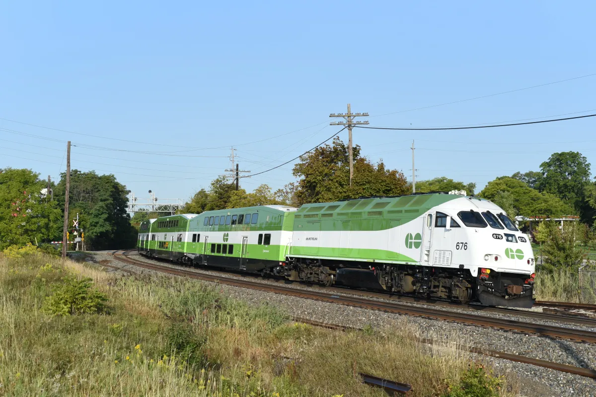 A GO Transit commuter train arriving at the station, serving the Milton to Toronto route.