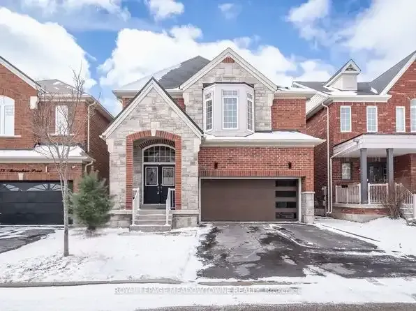 Stately brick detached home with a large driveway in the Harrison community.