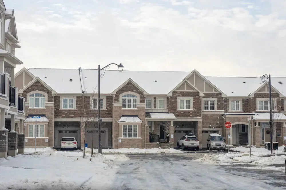 Row of newly built modern townhomes during winter in the Bowes community.