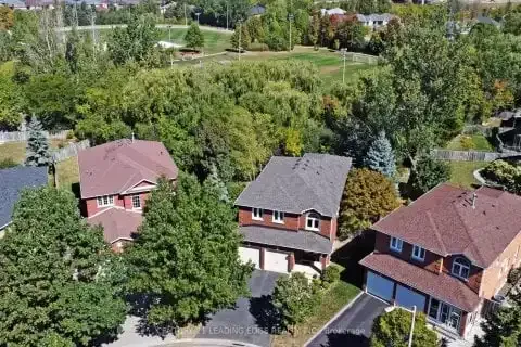 Aerial perspective of residential rooftops and trees in the Devonsleigh community.