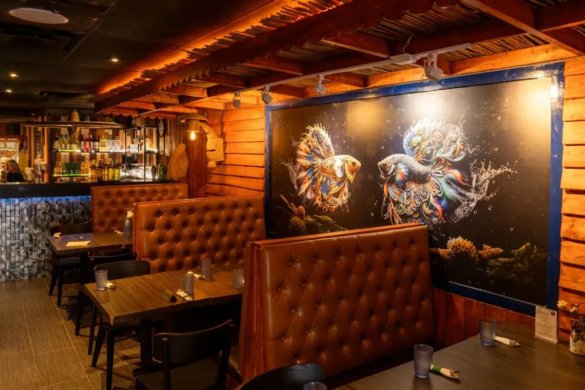 Atmospheric interior of Jatujak Thai Street Food restaurant featuring mural art.