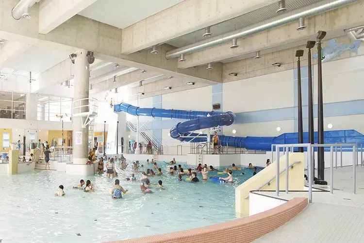 Interior view of the Richmond Hill Wave Pool featuring the water slide and swimming area.