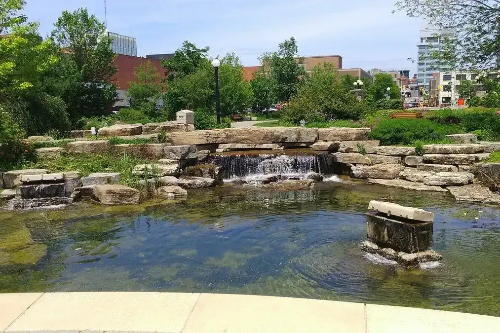Scenic stone waterfall and pond at Waterloo Park, a top local attraction.