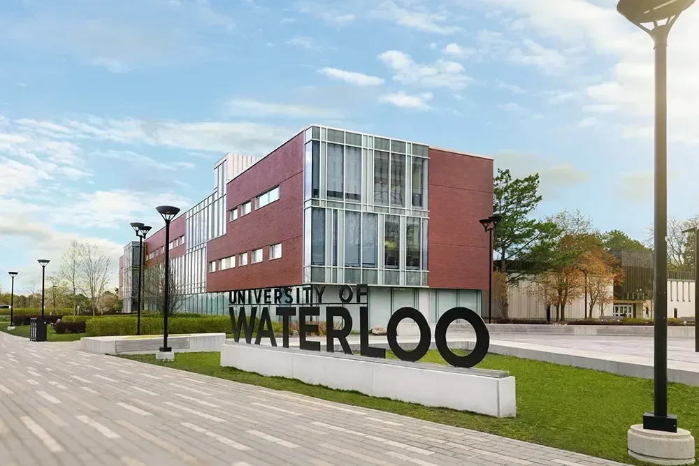 The iconic University of Waterloo entrance sign and campus building.