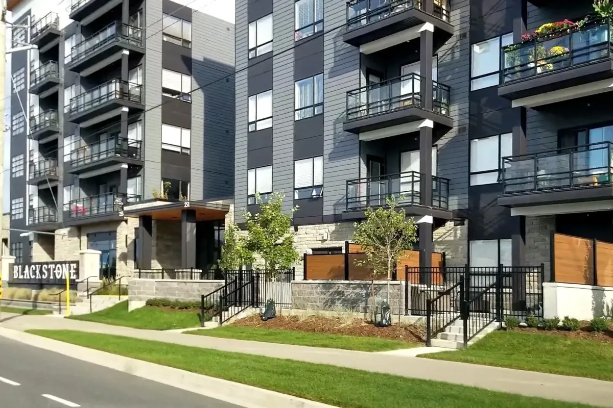 Modern multi-unit residential building with dark exterior in Colonial Acres.