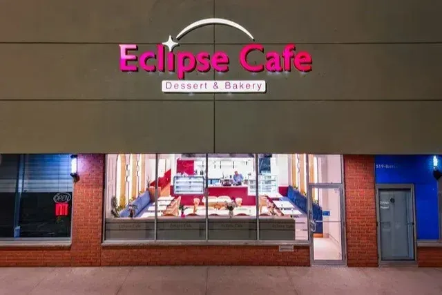 Storefront view of Eclipse Cafe Dessert and Bakery with bright signage.