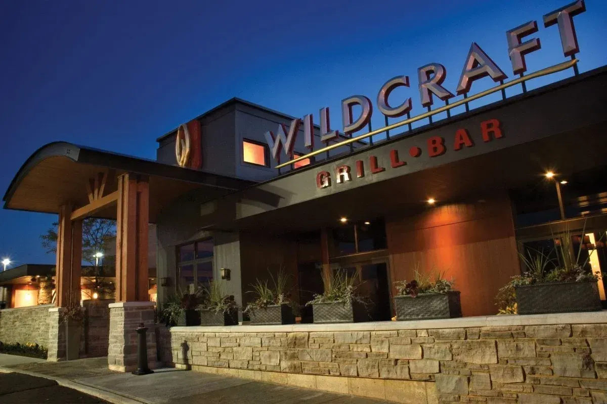 The exterior entrance of Wildcraft Grill and Long Bar in Waterloo at dusk.