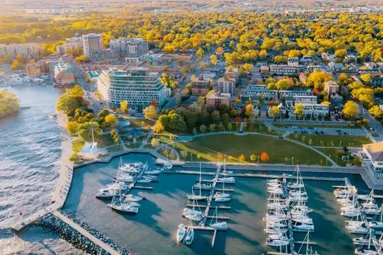 Aerial view of a marina with white boats and the Oakville waterfront park.