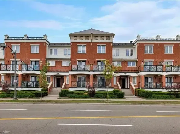 A row of modern brick and stone executive townhouses in Oakville's Uptown Core.