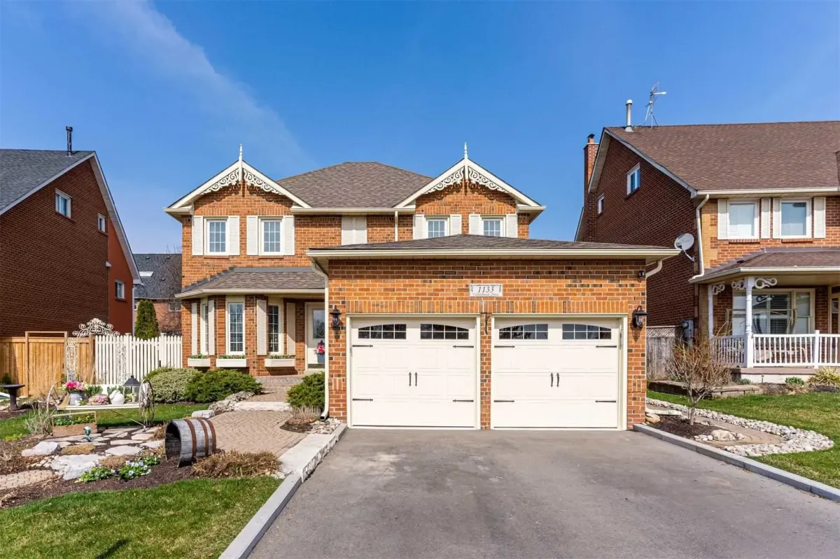 Modern detached brick homes on a sunny day in Iroquois Ridge, Oakville.