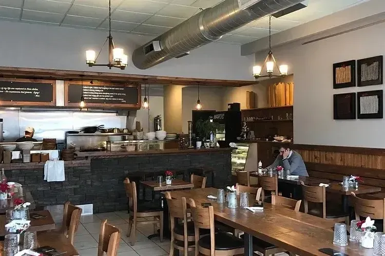 Interior of Maro’s Bistro in Oakville featuring cozy wooden tables and an open cafe atmosphere.