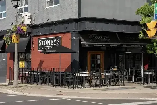 Corner view of the Stoney's Bread Company restaurant storefront with outdoor patio seating.