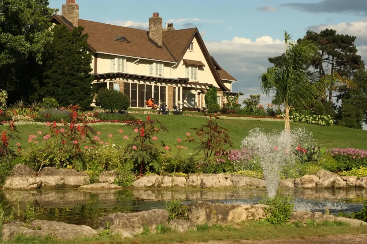 A beautiful flower garden and fountain in front of the historic house at Gairloch Gardens.