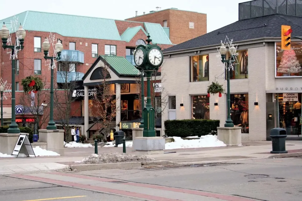 A street view of historic buildings and clock tower in the Old Oakville downtown area.