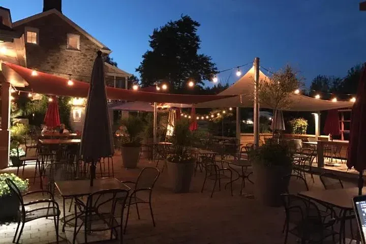 An outdoor restaurant patio in Caledon featuring warm string lighting and evening ambiance.