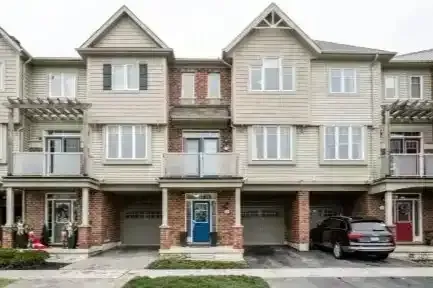 A row of contemporary multi-story townhouses in Caledon Village.