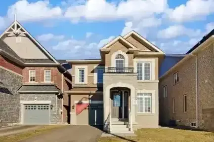 A large, modern detached estate home with a three-car garage in rural Caledon.