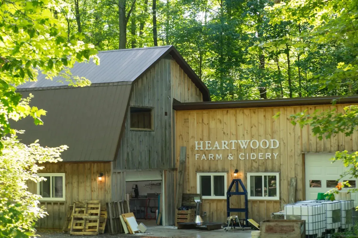 The rustic wooden barn entrance of Heartwood Farm and Cidery in Caledon.