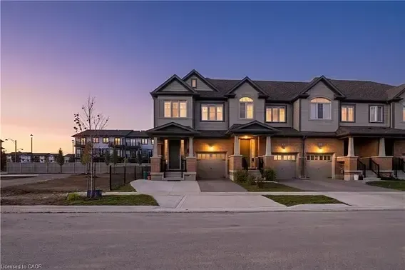 Modern townhome row at dusk in the Huron Park neighborhood, representing newer residential growth in Kitchener.