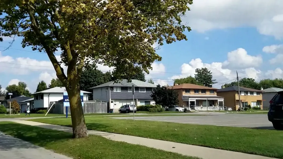 A quiet residential street in the Chicopee neighborhood of Kitchener, known for its family homes and proximity to outdoor recreation.