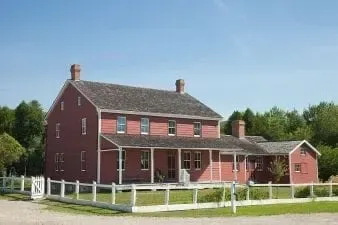 A historic red brick house at Doon Heritage Village, representing 1914 living history in Kitchener Ontario.