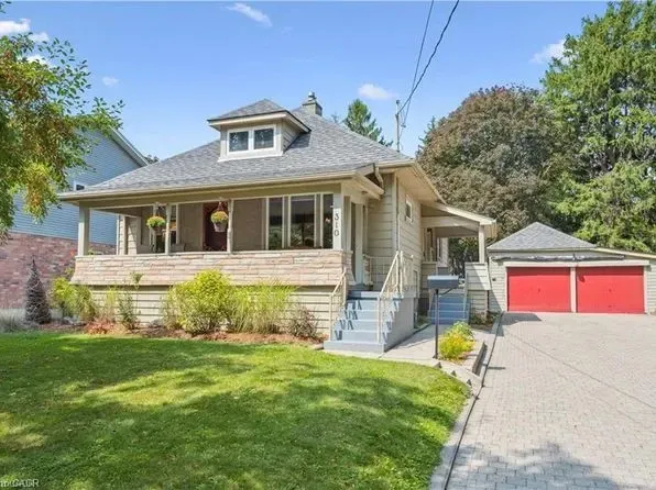 A charming yellow-brick bungalow with a large driveway in the Preston Heights area.