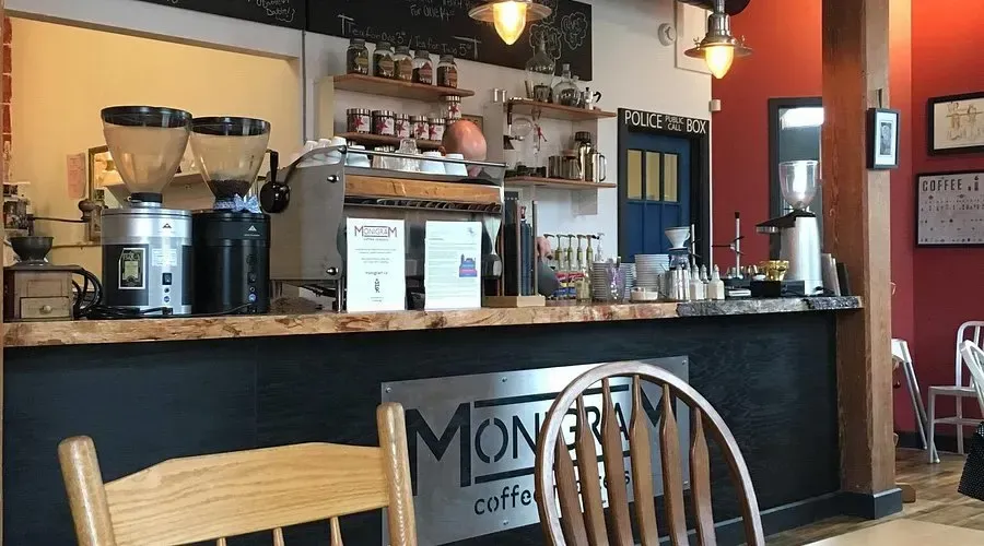 Interior bar and seating area of Monigram Coffee Roasters, showcasing their industrial-chic cafe space in Galt.