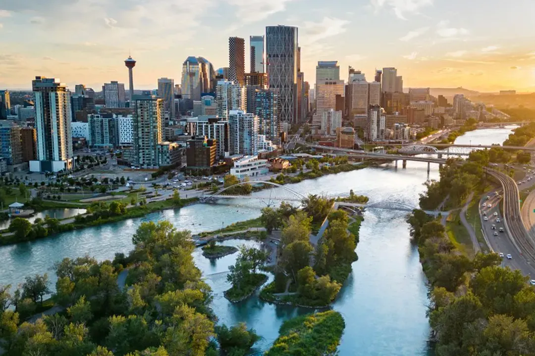 Panoramic aerial view of the Calgary skyline and Bow River, showcasing the urban landscape of Alberta's largest city.