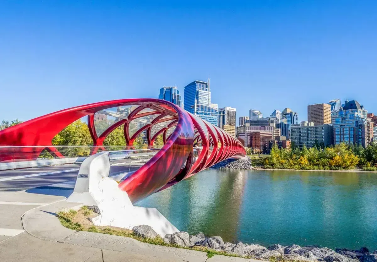 The iconic red Peace Bridge over the Bow River, a top landmark and pedestrian activity spot in Calgary.
