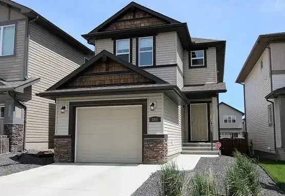 A modern two-story family home with an attached garage in the Panorama Hills neighborhood of NW Calgary.