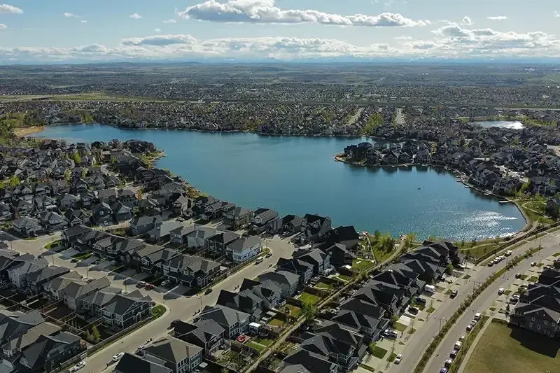 High-angle shot of the Auburn Bay community lake surrounded by residential homes.