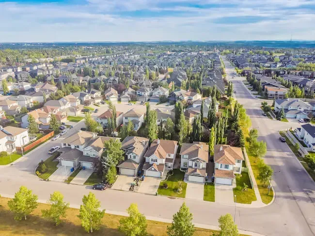 Uniform rows of contemporary family homes in the developing West Springs area of SW Calgary.