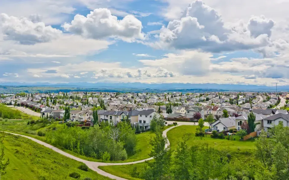 Scenic landscape view of the Tuscany neighborhood with the Rocky Mountains visible in the distance.