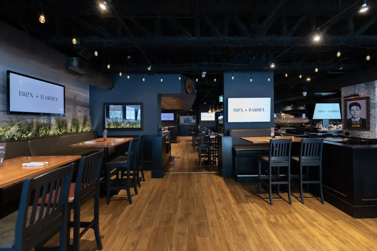 Dimly lit, sophisticated bar and lounge area at Brix + Barrel in Calgary.
