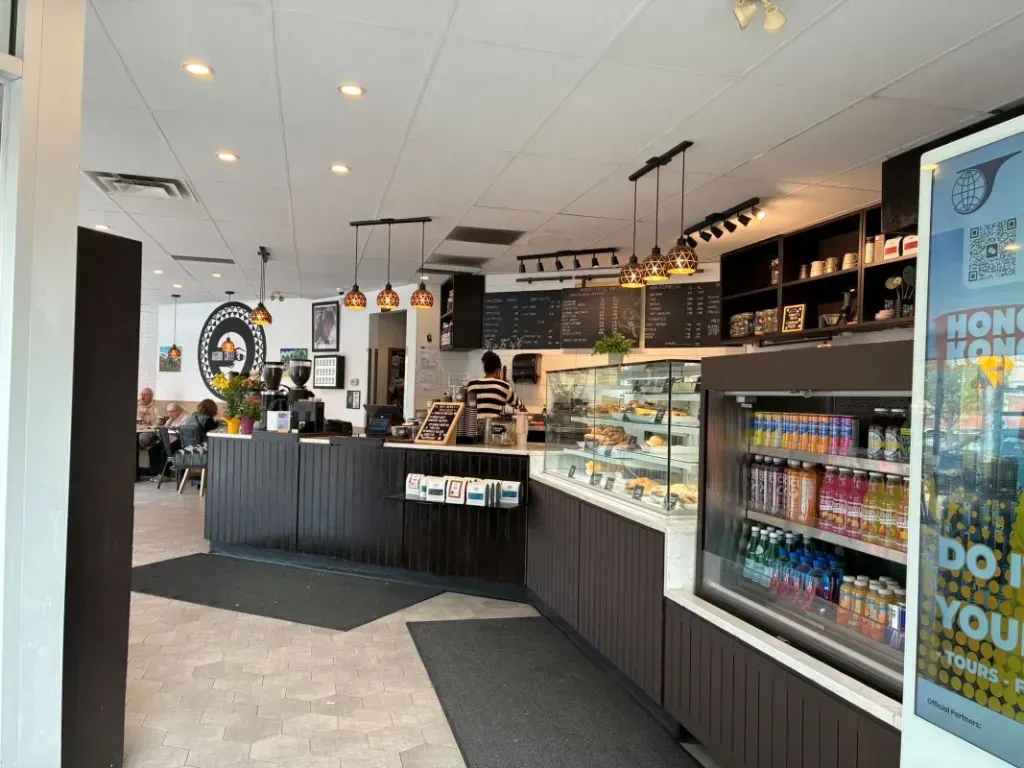 The clean, minimalist counter and interior of AGGÜDO COFFEE ROASTERS in Calgary.