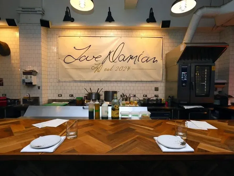 Beautifully set wooden table at Love Damian in Calgary, showcasing an inviting cafe atmosphere.