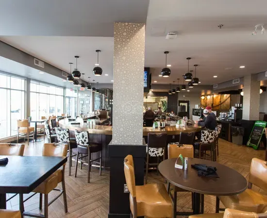 Sleek and modern interior of Tonic Kitchen + Bar in Calgary, featuring a contemporary bar and seating.