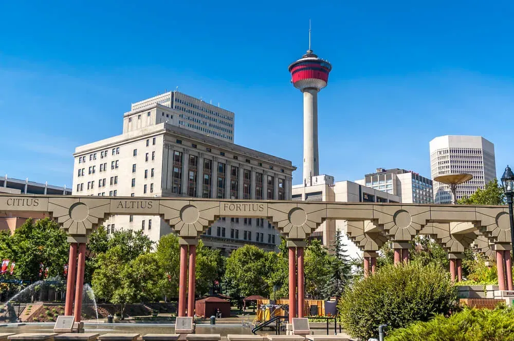 The iconic Calgary Tower standing tall against a blue sky in the heart of downtown.