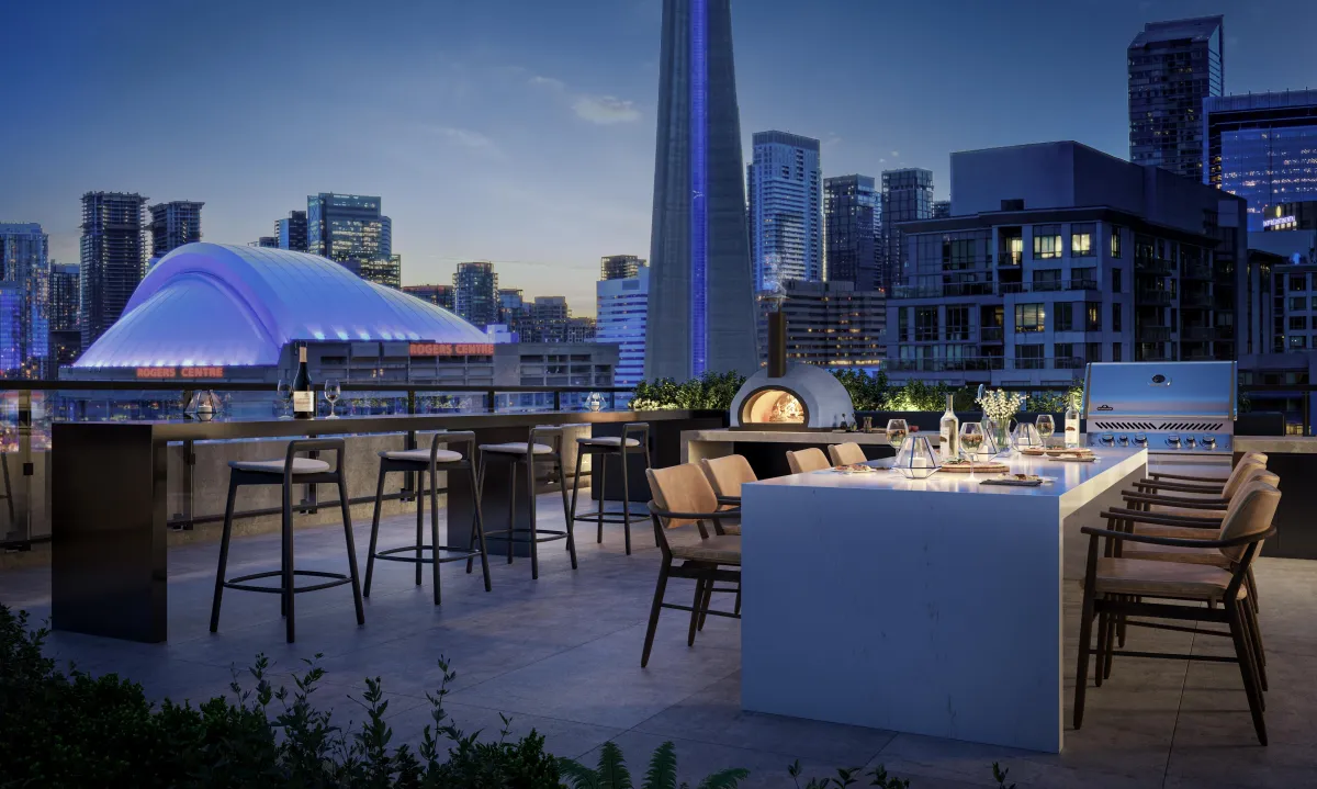 Rooftop terrace with outdoor kitchen and dining overlooking the CN Tower at Q Tower.