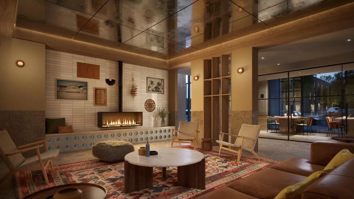 Cozy fireside resident lounge with library-style shelving and mid-century modern furniture at Westbend.