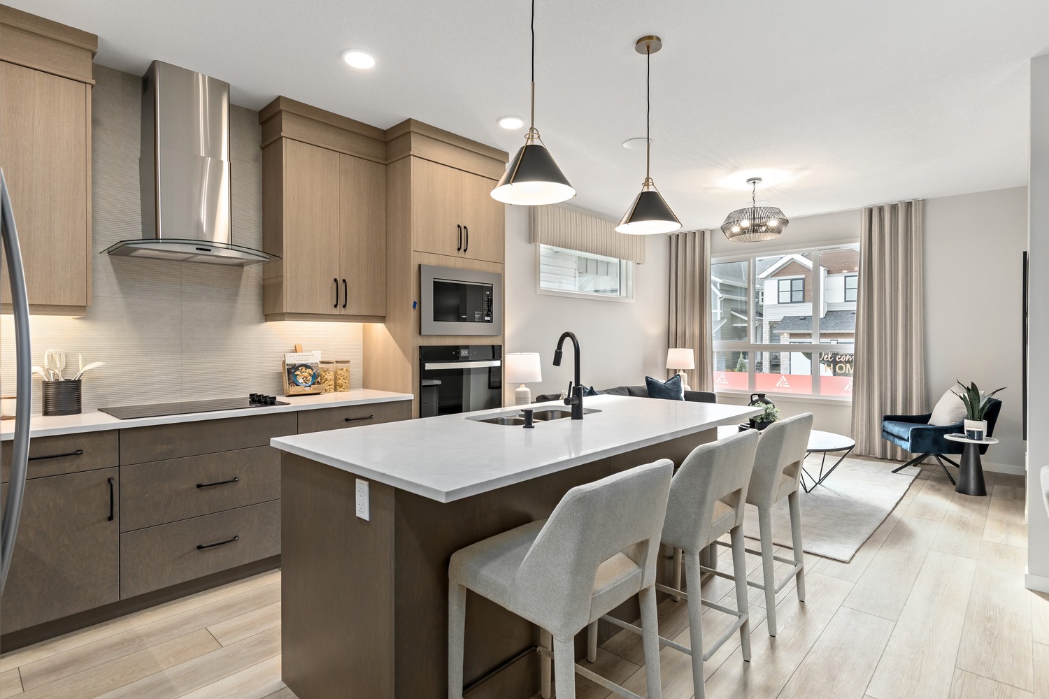 High-end kitchen with integrated appliances and elegant dining space at 9Hundred Condos.