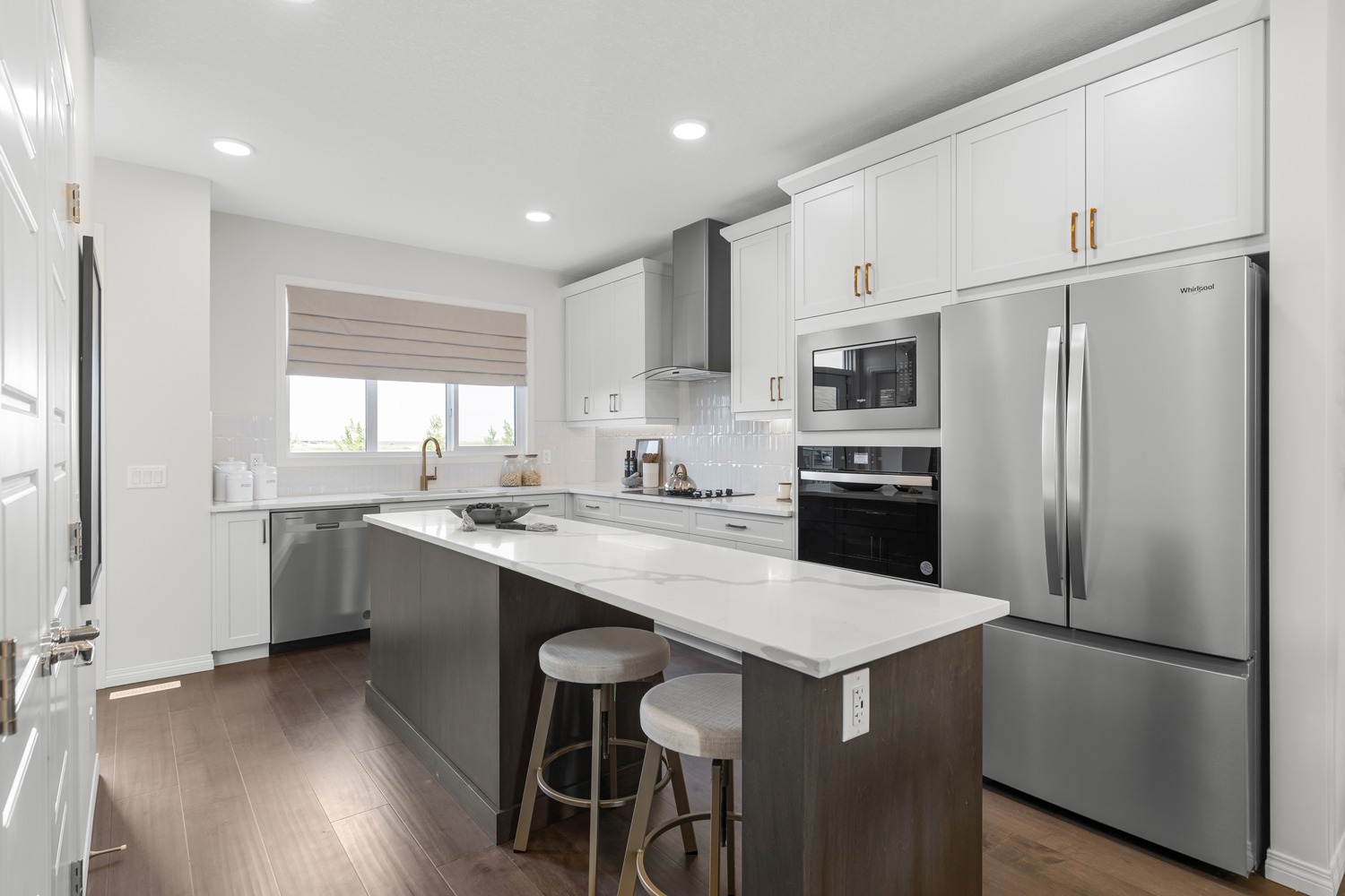 High-end kitchen with integrated appliances and elegant dining space at 9Hundred Condos.