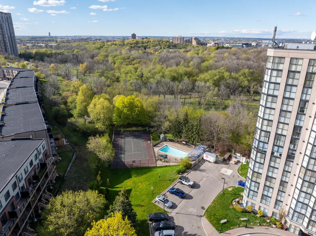 Aerial view of the building's outdoor pool and tennis court facilities.