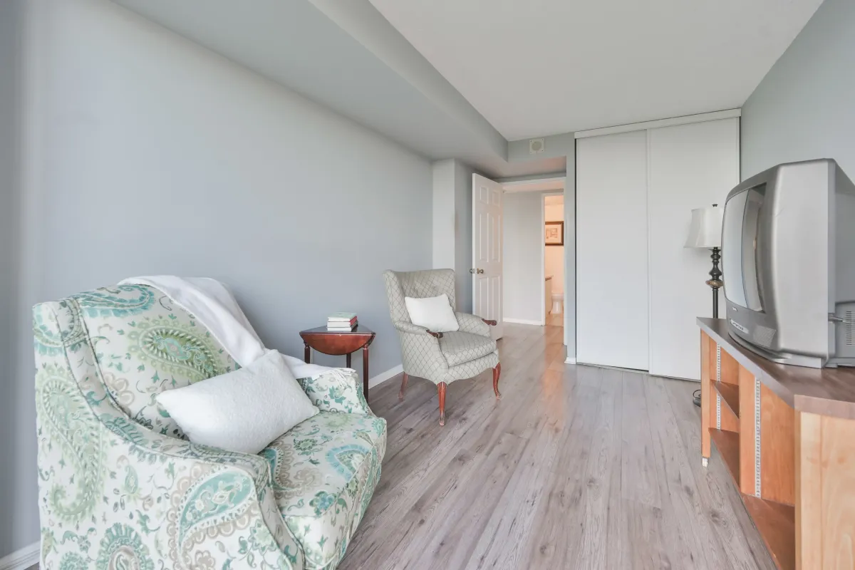 Interior view of a spacious secondary bedroom with neutral tones and laminate flooring.
