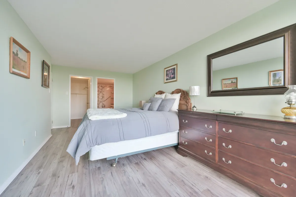 Well-appointed primary bedroom featuring ample space for a king-sized bed and dresser.