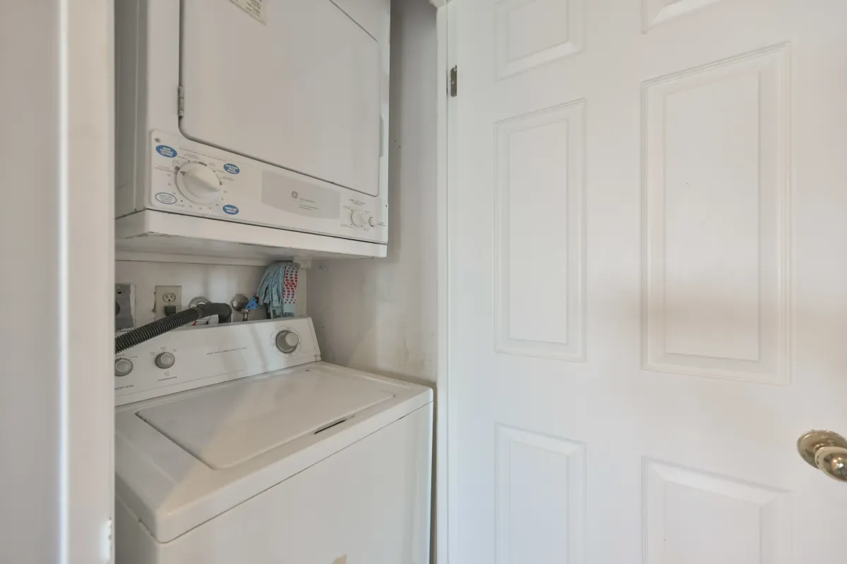 Convenient in-suite laundry area with stacked washer and dryer.