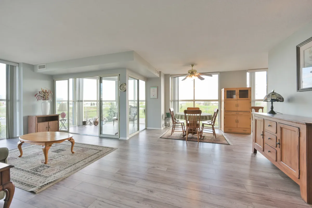 Spacious open-concept dining and living area with floor-to-ceiling windows.